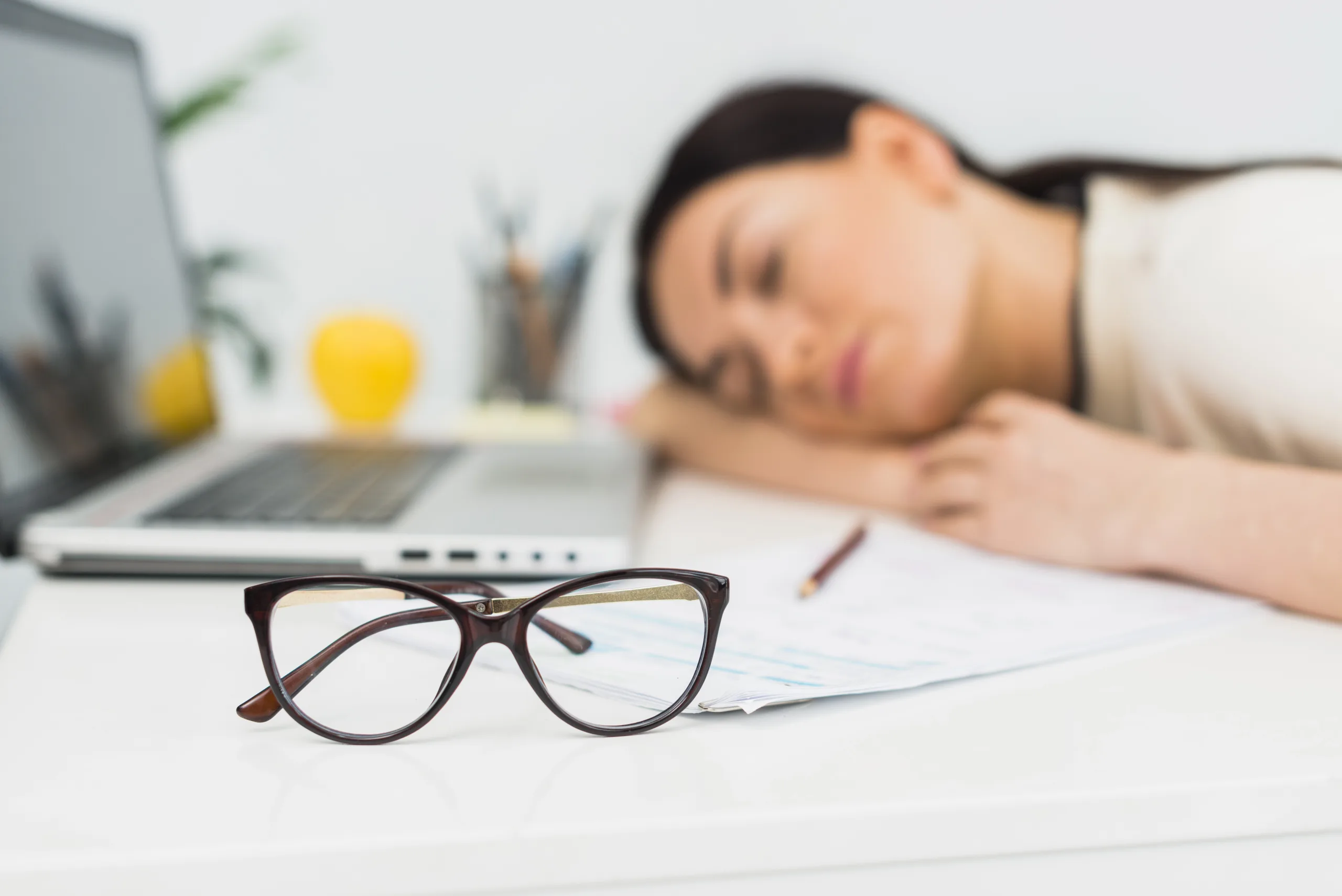 glasses-sleeping-woman-table-office